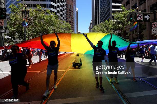 Marchers carry an oversized Pride flag during the 52nd annual San Francisco Pride Parade and Celebration on June 26, 2022 in San Francisco,...