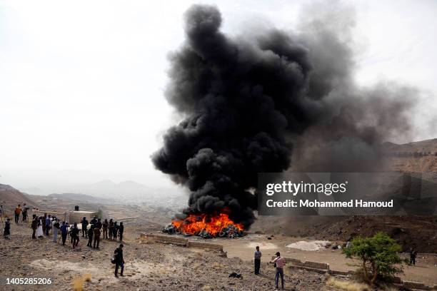 Yemeni security members participate in destroying narcotic drugs, seized in past 6-month of this year, during a destruction ceremony to commemorate...