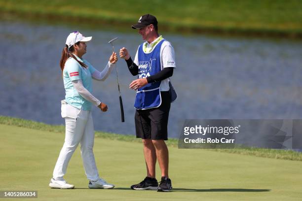 Hye-Jin Choi of South Korea reacts with her caddie after making birdie on the 18th green during the final round of the KPMG Women's PGA Championship...