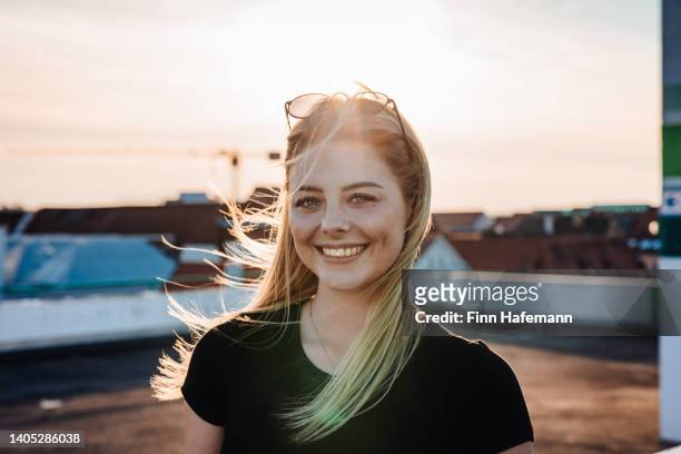 happy smilling blonde woman outdoor urban sunset lifestyle portrait - portrait of young woman standing against steps stock pictures, royalty-free photos & images