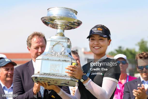 In Gee Chun of South Korea smiles with the championship trophy during the presentation ceremony after winning during the final round of the KPMG...