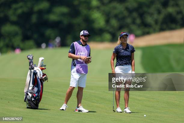 Lexi Thompson of the United States waits with caddie Will Davidson before playing an approach shot during the final round of the KPMG Women's PGA...
