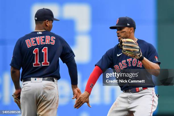 Rafael Devers and Xander Bogaerts of the Boston Red Sox celebrate the team's 8-3 win over the Cleveland Guardians at Progressive Field on June 26,...