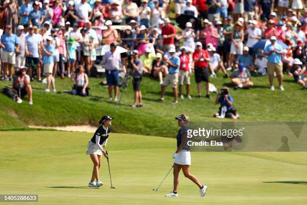 In Gee Chun of South Korea and Lexi Thompson of the United States stand on the 18th green during the final round of the KPMG Women's PGA Championship...