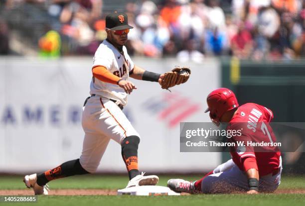 Thairo Estrada of the San Francisco Giants steps on second base to get the put out on Donovan Solano of the Cincinnati Reds in the top of the second...