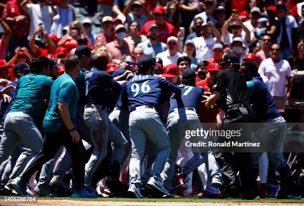 The Seattle Mariners and the Los Angeles Angels clear the benches after Jesse Winker of the Seattle Mariners charged the Angels dugout after being...