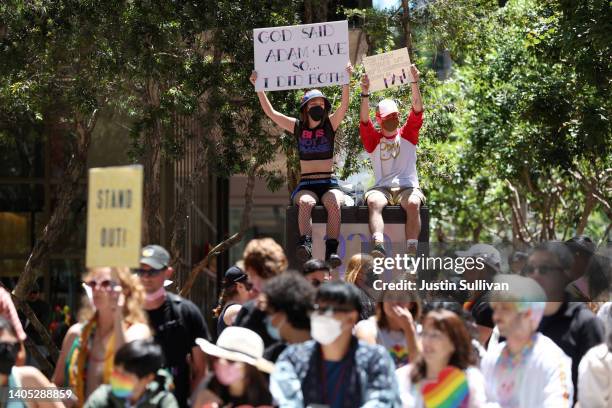 Parade goers hold signs as they line the route of the 52nd Annual San Francisco Pride Parade and Celebration on June 26, 2022 in San Francisco,...