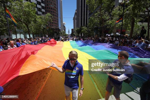 Marchers carry an oversized Pride flag during the 52nd Annual San Francisco Pride Parade and Celebration on June 26, 2022 in San Francisco,...