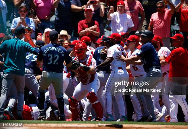 The Seattle Mariners and the Los Angeles Angels clear the benches after Jesse Winker of theMariners charged the Angels dugout after being hit by a...