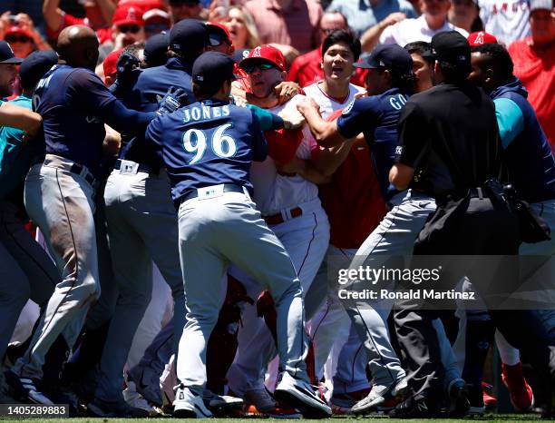 The Seattle Mariners and the Los Angeles Angels clear the benches after Jesse Winker of the Seattle Mariners charged the Angels dugout after being...