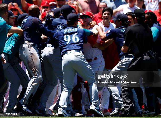 The Seattle Mariners and the Los Angeles Angels clear the benches after Jesse Winker of the Seattle Mariners charged the Angels dugout after being...