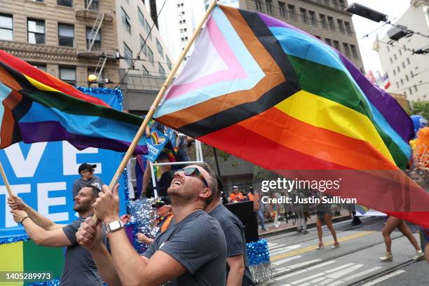 Marchers hold Pride flags as they participate the 52nd Annual San Francisco Pride Parade and Celebration on June 26, 2022 in San Francisco,...