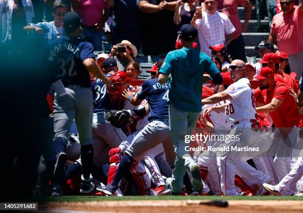 The Seattle Mariners and the Los Angeles Angels clear the benches after Jesse Winker of the Seattle Mariners charged the Angels dugout after being...