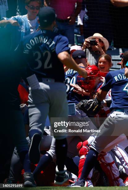 The Seattle Mariners and the Los Angeles Angels clear the benches after Jesse Winker of the Seattle Mariners charged the Angels dugout after being...