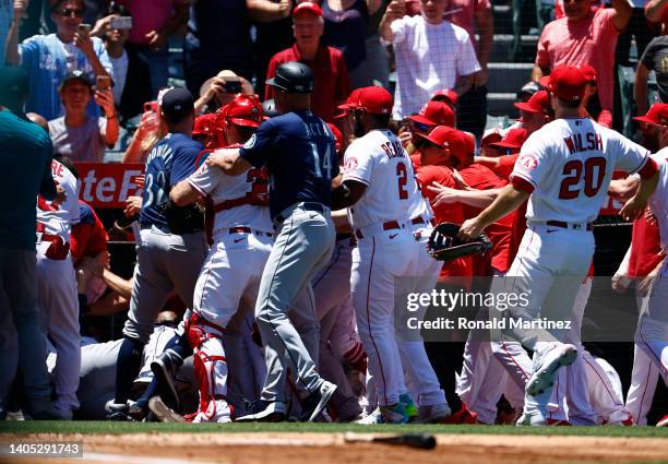 The Seattle Mariners and the Los Angeles Angels clear the benches after Jesse Winker of the Seattle Mariners charged the Angels dugout after being...