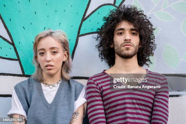 portrait of a non binary person and friend looking at camera - androgynous stock pictures, royalty-free photos & images