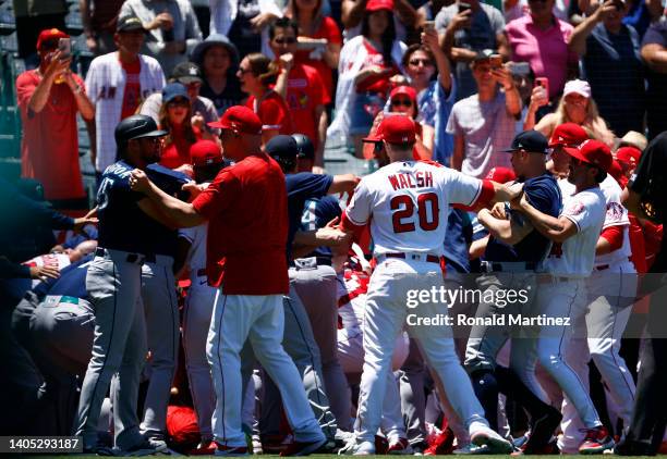 The Seattle Mariners and the Los Angeles Angels clear the benches after Jesse Winker of the Seattle Mariners charged the Angels dugout after being...