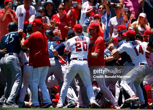 The Seattle Mariners and the Los Angeles Angels clear the benches after Jesse Winker of the Seattle Mariners charged the Angels dugout after being...