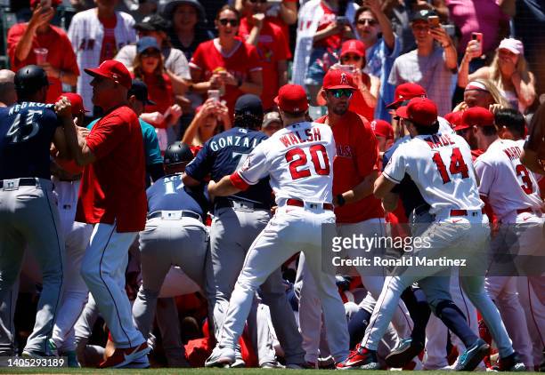 The Seattle Mariners and the Los Angeles Angels clear the benches after Jesse Winker of the Seattle Mariners charged the Angels dugout after being...