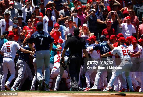 The Seattle Mariners and the Los Angeles Angels clear the benches after Jesse Winker of the Seattle Mariners charged the Angels dugout after being...