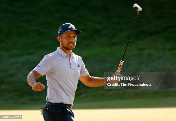 Xander Schauffele of the United States reacts after putting in to win on the 18th green during the final round of Travelers Championship at TPC River...