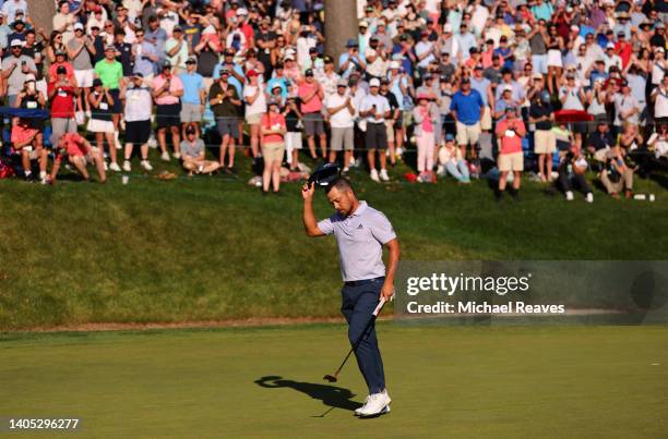 Xander Schauffele of the United States reacts after putting in to win on the 18th green during the final round of Travelers Championship at TPC River...