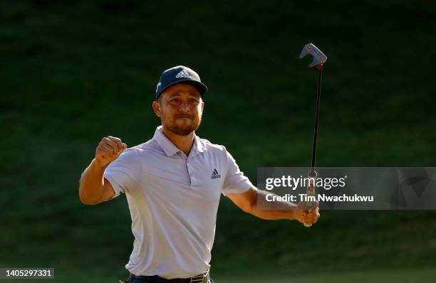 Xander Schauffele of the United States reacts after putting in to win on the 18th green during the final round of Travelers Championship at TPC River...