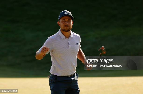 Xander Schauffele of the United States reacts after putting in to win on the 18th green during the final round of Travelers Championship at TPC River...