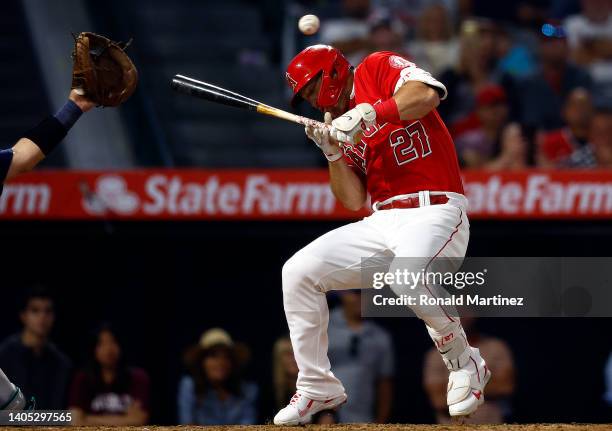 Mike Trout of the Los Angeles Angels dodges a foul ball against the Seattle Mariners at Angel Stadium of Anaheim on June 25, 2022 in Anaheim,...