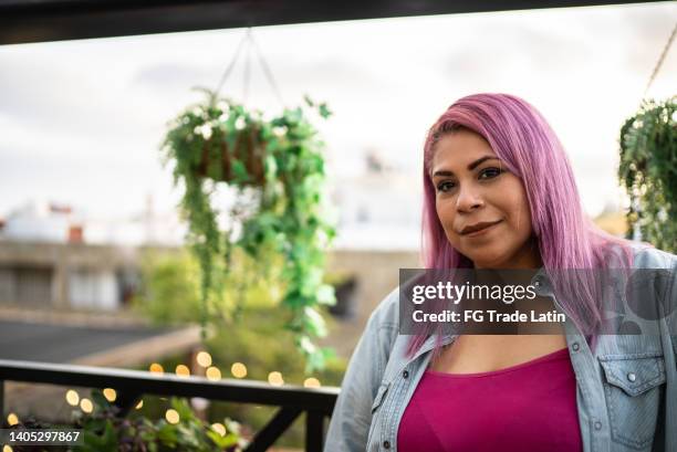 portrait of mid adult woman at rooftop - skin tone stock pictures, royalty-free photos & images