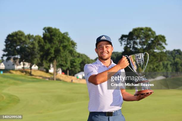 Xander Schauffele of the United States poses with the trophy after putting in to win on the 18th green during the final round of Travelers...