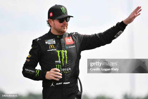 Kurt Busch, driver of the Monster Energy Toyota, waves to fans onstage during driver intros prior to the NASCAR Cup Series Ally 400 at Nashville...