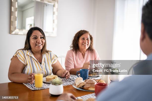 mother and daughter having breakfast at home - mature women eating stock pictures, royalty-free photos & images