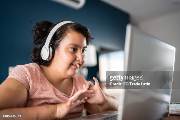 psychomotor retardation girl using laptop studying at home - developmental disability stock pictures, royalty-free photos & images