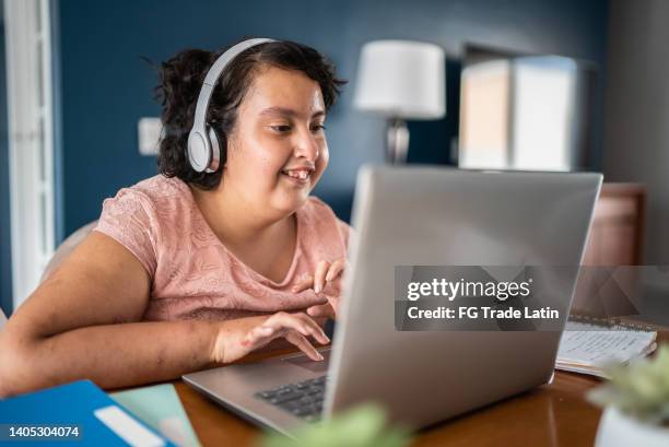 psychomotor intellectual disability girl using laptop studying at home - disability computer stock pictures, royalty-free photos & images