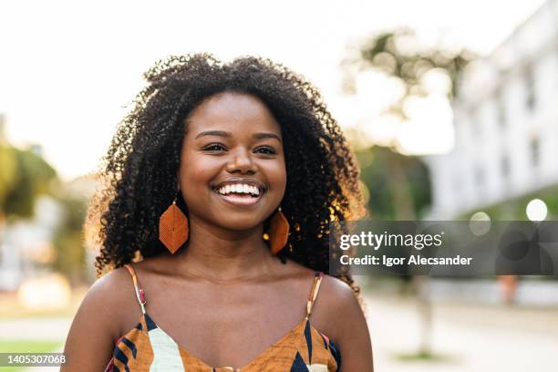 smiling young woman in the city - candid beautiful young woman face stock pictures, royalty-free photos & images