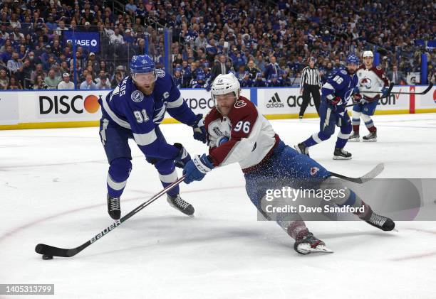 Mikko Rantanen of the Colorado Avalanche centers the puck past Steven Stamkos of the Tampa Bay Lightning in the first period of Game Six of the 2022...