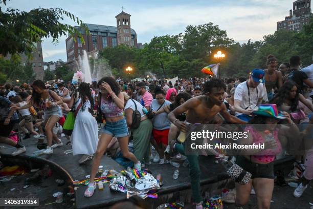 People run out of Washington Square Park after fireworks were mistaken for gunfire following multiple Pride events earlier in the day on June 26,...