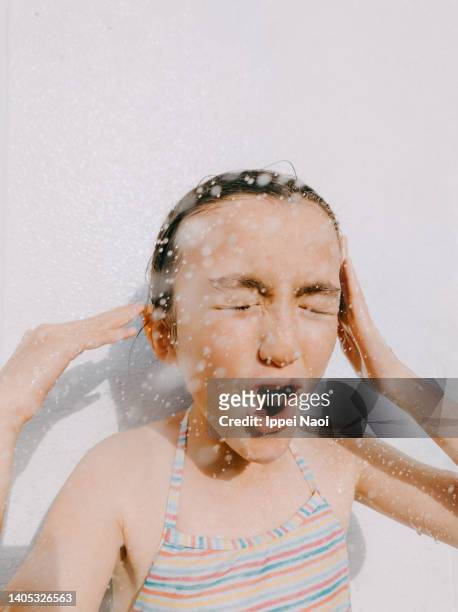 young girl enjoying outdoor shower - japanese girls hot fotografías e imágenes de stock