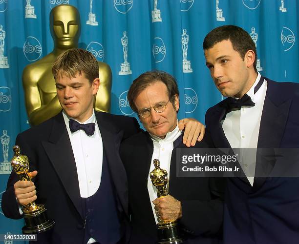 Oscar Winner Robin Williams joins winners Ben Affleck and Matt Damon as they hold their Oscar Award backstage at Academy Awards Show, March 23, 1998...