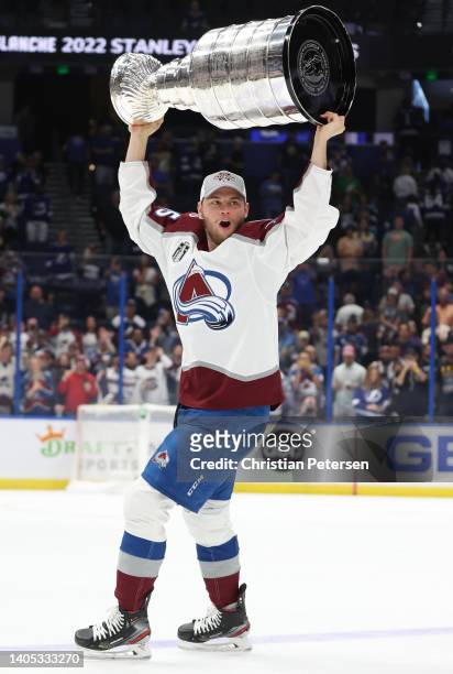 Andre Burakovsky of the Colorado Avalanche lifts the Stanley Cup after defeating the Tampa Bay Lightning 2-1 in Game Six of the 2022 NHL Stanley Cup...