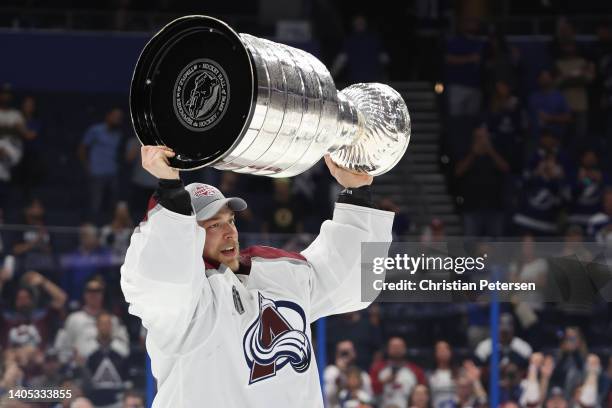 Darcy Kuemper of the Colorado Avalanche lifts the Stanley Cup after defeating the Tampa Bay Lightning 2-1 in Game Six of the 2022 NHL Stanley Cup...