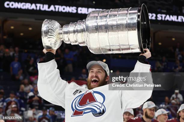 Darcy Kuemper of the Colorado Avalanche lifts the Stanley Cup after defeating the Tampa Bay Lightning 2-1 in Game Six of the 2022 NHL Stanley Cup...