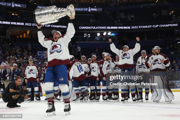 Jacob MacDonald of the Colorado Avalanche lifts the Stanley Cup after defeating the Tampa Bay Lightning 2-1 in Game Six of the 2022 NHL Stanley Cup...