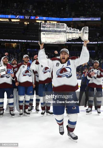 Nathan MacKinnon of the Colorado Avalanche hoists the Stanley Cup after the Colorado Avalanche defeated the Tampa Bay Lightning in Game Six of the...