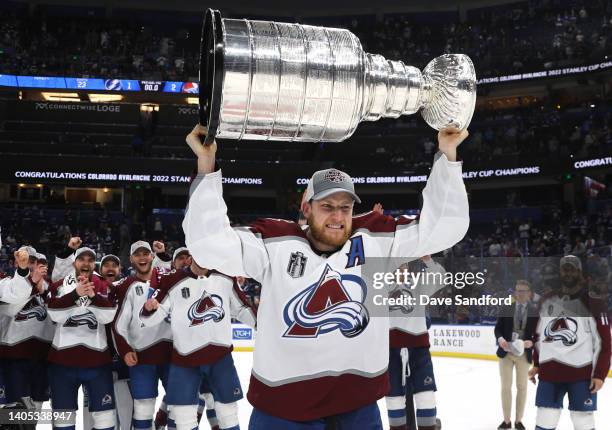 Nathan MacKinnon of the Colorado Avalanche hoists the Stanley Cup after the Colorado Avalanche defeated the Tampa Bay Lightning in Game Six of the...