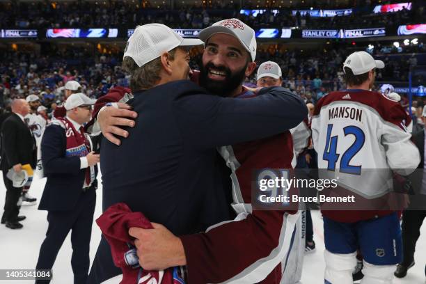 Nazem Kadri of the Colorado Avalanche hugs General Manager Joe Sakic after defeating the Tampa Bay Lightning 2-1 in Game Six of the 2022 NHL Stanley...