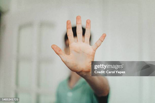 young male teenager  open palm.stop gesture - bullying stock-fotos und bilder