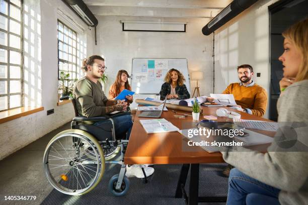 happy disabled businessman having a meeting with his colleagues. - ortopedisk utrustning bildbanksfoton och bilder