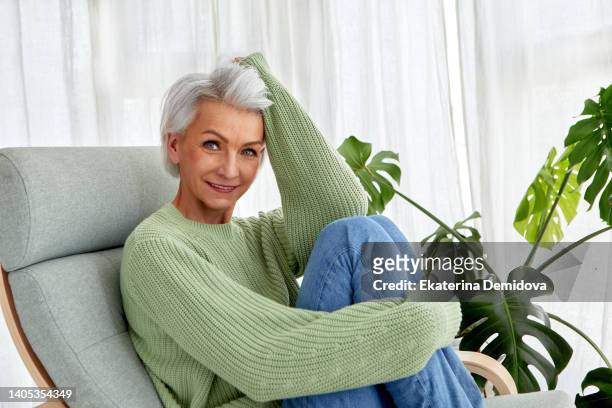 stylish senior woman resting on rocking chair - russian mature women 個照片及圖片檔